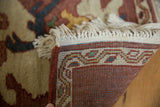 Intact original selvage, cream fringe, and woven border of the vintage Armenian rug.