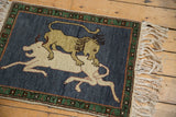 Lion's head and forest green border with madder root rust accents on the pictorial Armenian rug.