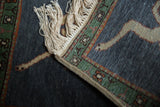 Ecru fringe, intact woven selvage, and forest green geometric border of the vintage Armenian rug.