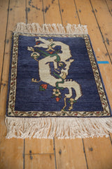 Angled view of a pictorial Armenian rug featuring an ivory dragon on a cobalt blue field.