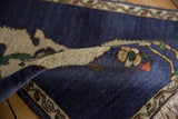 The like-new, full pile of a hand-knotted Armenian rug seen on a rolled corner.