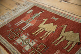 Close view of the pictorial herdsman and camels on a hand-knotted vintage Armenian rug.