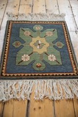 An angled perspective of the vintage Yerevan square rug, highlighting its full pile and geometric medallion.