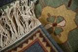 Full pile texture, original side cord selvedge, and cream fringe on a vintage rug.