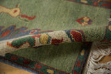 Thick emerald green pile, original selvage, and meandering boteh border of vintage Armenian rug.