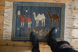 Natural fringe, terracotta horse, and herdsman on denim blue pictorial rug.