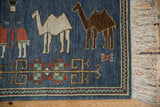 Dark chocolate brown camel design, red chevron border, and ivory fringe on the Armenian pictorial rug.