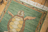 Vintage Armenian rug corner: emerald green abrashes field and multicolored vine border detail.
