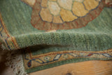 Full emerald green pile of a vintage Armenian rug, showing meandering vine border and fringe.