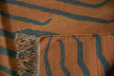 Intact side cord selvage and fringe of the handwoven Tiger Kilim carpet.