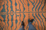 Expansive tiger stripe pattern with subtle abrashes in pale rust and dark teal kilim weave.