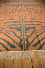 Cream fringe and flatweave texture with pale rust and charcoal tiger stripes.