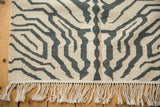 Ivory and charcoal-navy zebra pattern with subtle abrashes on a hand-woven kilim.
