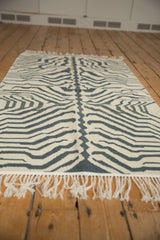 Short, textured ivory fringe with a pale dusty navy zebra pattern.