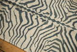 Hand-woven vintage Kilim texture: ivory and charcoal zebra pattern with subtle abrashes.