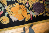 Plush Art Deco rug displaying large gold starburst flowers, mauve, green, and striped border.