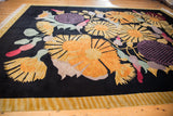 Art Deco starburst floral bouquet with gold, pink, green blossoms on black ground.