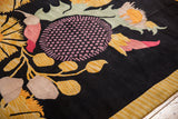 Indian Art Deco carpet's golden ribbed border and pink blossoms.