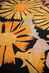Oversized Art Deco gold and orange floral blossoms on plush black pile.