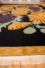 Clean white fringe and plush gold border of the vintage Indian Art Deco carpet.