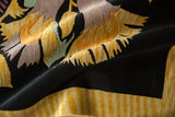 Plush black Art Deco carpet pile, gold and mauve starburst floral with striped border.