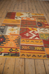 Geometric patchwork panels featuring warm tones and distinct cross-stitch seams.