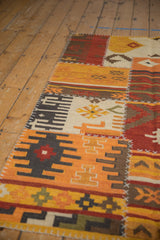 Geometric patchwork Kilim with finned guls, ram's horn motifs, and distinct cross-hatch stitching.