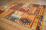 Close-up of hand woven kilim patchwork featuring geometric guls, rams horn motifs, and cross-hatch stitching.