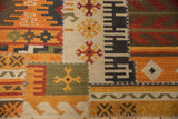 Patchwork kilim detail shows geometric panels, finned guls, and raised cross-hatch stitching.