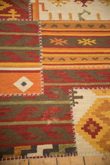 Textured patchwork kilim with geometric finned guls, rams horn motifs, and cross hatch stitches.