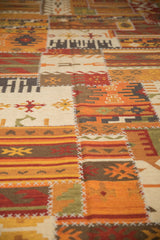 Geometric patchwork Kilim panels with finned guls, rams horn motifs, and white cross-hatch stitching.