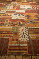 Warm toned hand woven Kilim carpet, showcasing geometric finned guls and cross stitch seams.