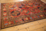 Pakistani Ersari design carpet featuring a geometric side border and rich gem-tone guls.