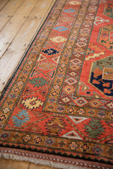 Geometric cherry red, sapphire blue Ersari design rug showing plush pile and fringe.