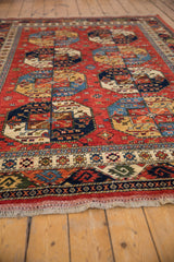 Geometric guls and borders in cherry red, sapphire blue, gold wool pile.