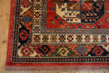 Corner detail of Ersari rug with red and blue geometric borders, bold palmettes, and fringe.