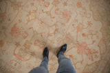 Decorative distressed Indian Soumac carpet detail with faded floral palmettes and vinery.