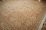 Intricate floral borders and curvilinear vine motifs on a distressed Indian Soumac rug.