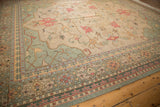 Hand woven Soumac carpet corner with intricate pale terra cotta floral buds and green vinery.
