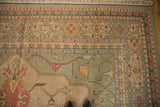 Vintage Indian Soumac rug corner with intricate palmette vinery, seafoam green, and beige tones.