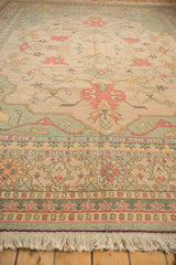 Vibrant pale terra cotta palmette, seafoam green vinery on antique ivory Indian Soumac rug.