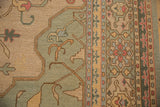 Hand woven Indian Soumac carpet border detail showing vinery, floral palmettes, seafoam, and beige.