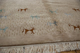 Angled detail of a folk art rug's carved beige pile with lustrous animal motifs and a neat ivory fringe.