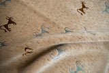 A draped view showing the full, carved pile and folk art animal motifs in art silk.
