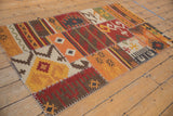 Patchwork Kilim rug featuring geometric and primitive panels with distinct cross-stitch seams.