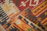 Indian patchwork kilim rug corner, showcasing geometric motifs, warm tones, and cross-hatch stitching.