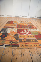 Warm-toned patchwork Kilim panels, showcasing geometric motifs and white cross-hatch stitches.