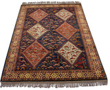 Angled view of a lustrous vintage Indian rug with stepped geometric medallions.