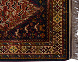 Secure corner of a vintage Indian rug with lustrous pile, geometric borders, and original selvage.