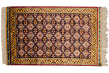 Vintage Indian Caucasian design rug with an allover geometric pattern in navy blue, gold, and wine red.